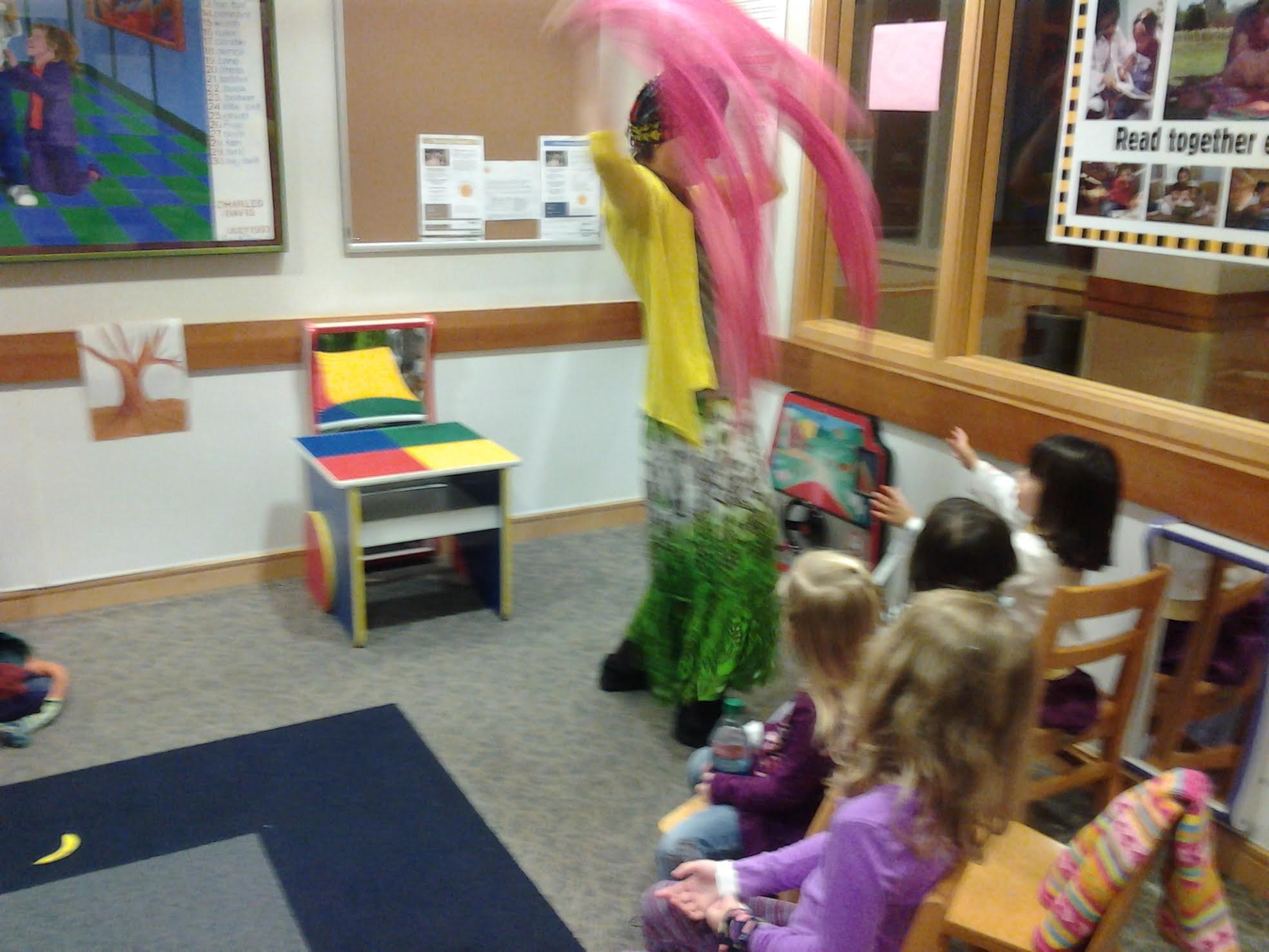 Andrea doing storytelling for children using scarves in a classroom
